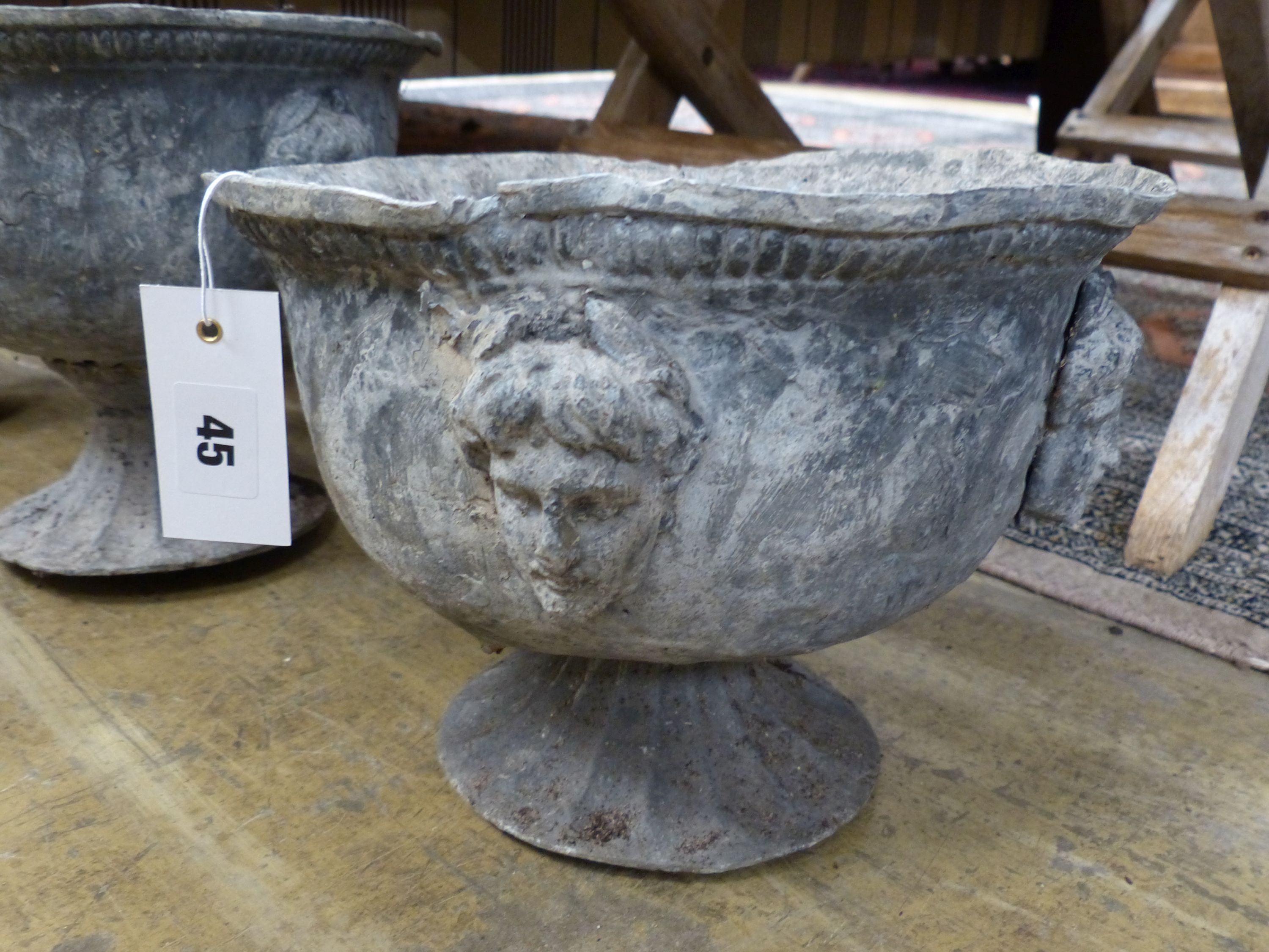 A pair of early 20th century lead garden urns, diameter 26cm, height 23cm